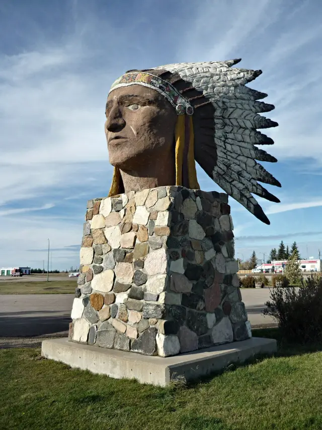 Giant Indian head statue on a fieldstone base