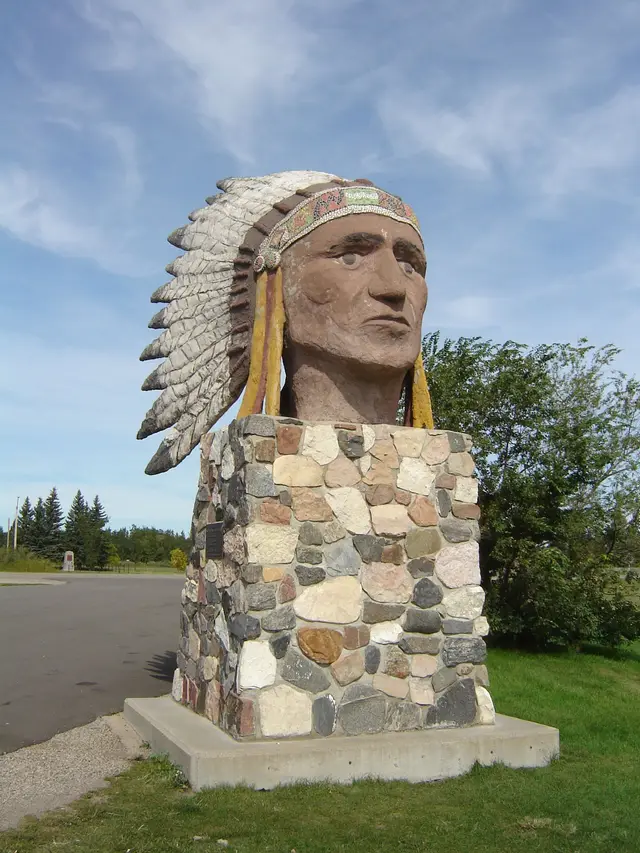 The Indian Head statue on a fieldstone base